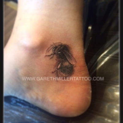 black and grey bee on ankle realism soft shading tattoo leeds