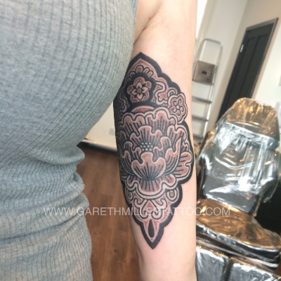 geometric flower mandala on arm dotwork tattoo leeds