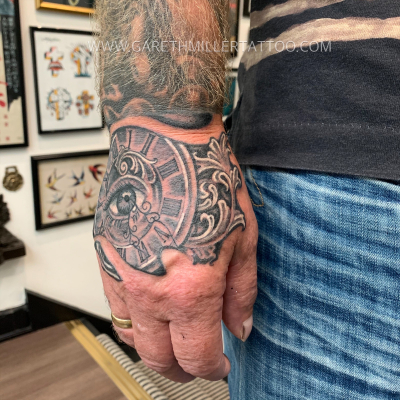 pocketwatch eye hand tattoo black and grey tattoo leeds